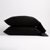 Bria Standard Pillowcase (Single) | Corvino | Two cotton sateen sleeping pillows, stacked neatly against a white backdrop - side view.