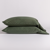 Bria Pillowcase (Single) | Juniper | two cotton sateen sleepign pillows, stacked neatly against a white backdrop.