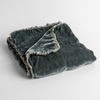 Carmen Baby Blanket | Mineral | silk velvet baby blanket with charmeuse trim shown slightly overhead with a corner folded back to show trim detail against a white background.