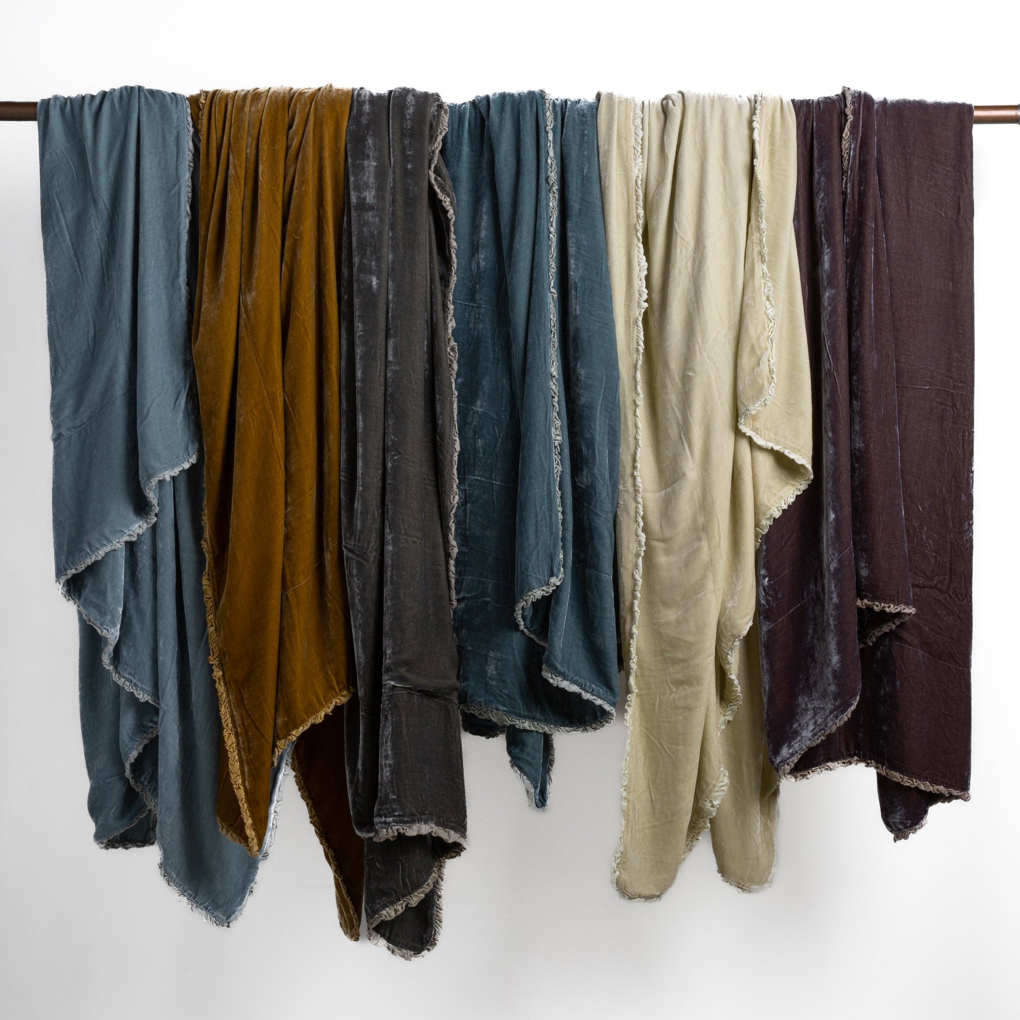 Carmen Blanket | carmen throw blankets draped over a bar showing drape of the unfilled blankets.