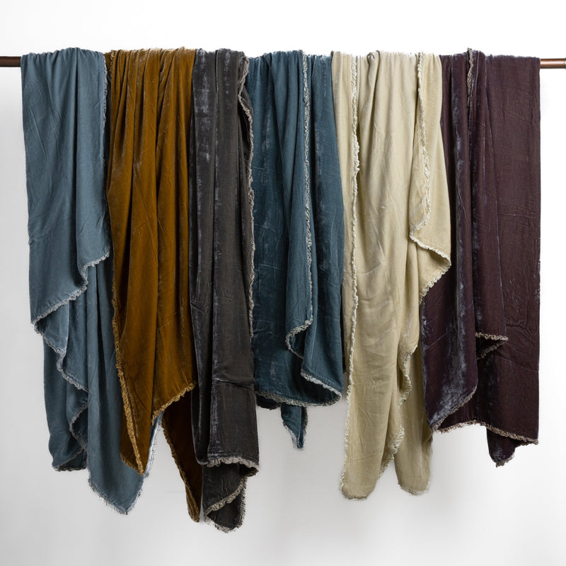 Carmen Blanket | carmen throw blankets draped over a bar showing drape of the unfilled blankets.