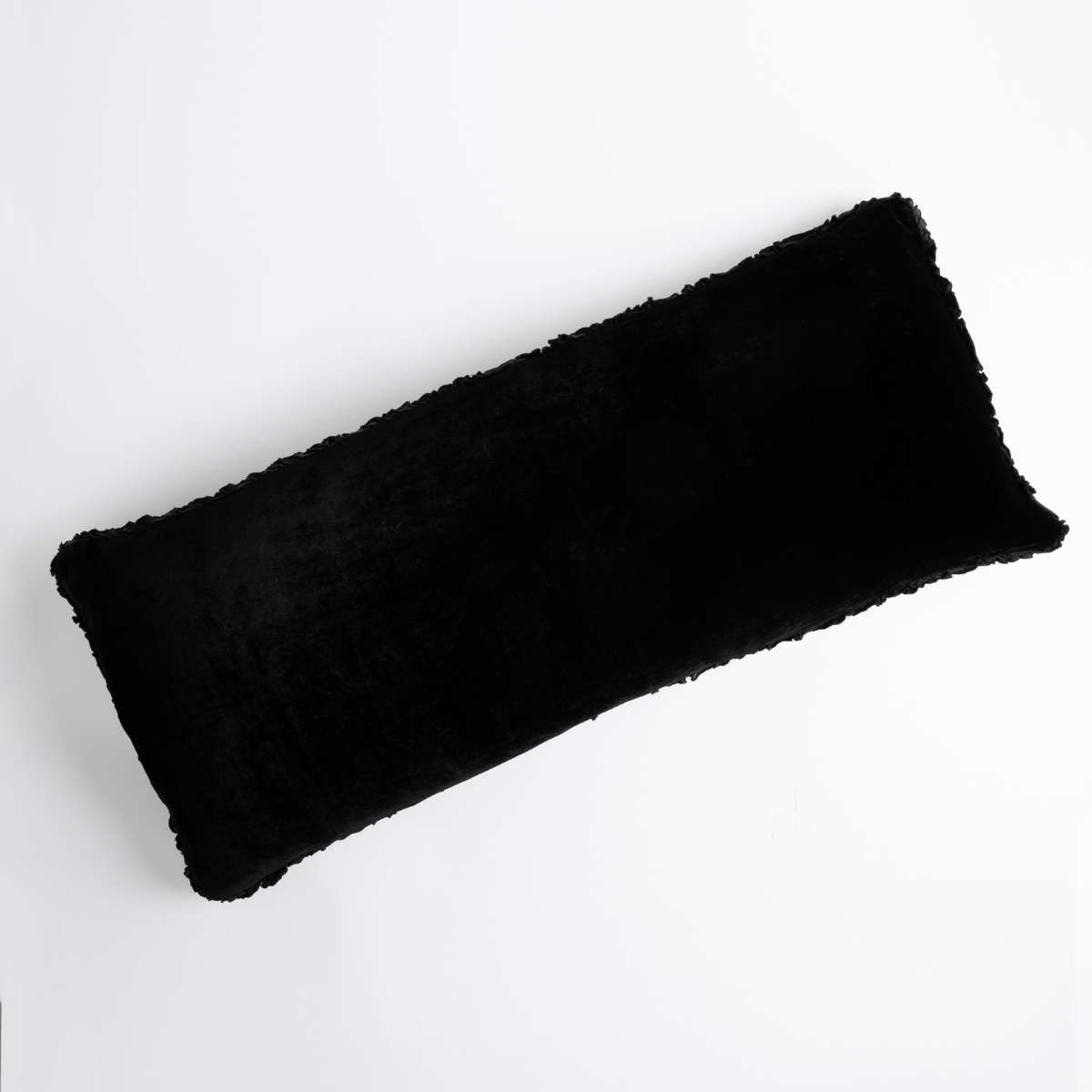 Carmen Throw Pillow | Corvino | pillow laid on a plain white background, petite ruffle detail on all four sides.