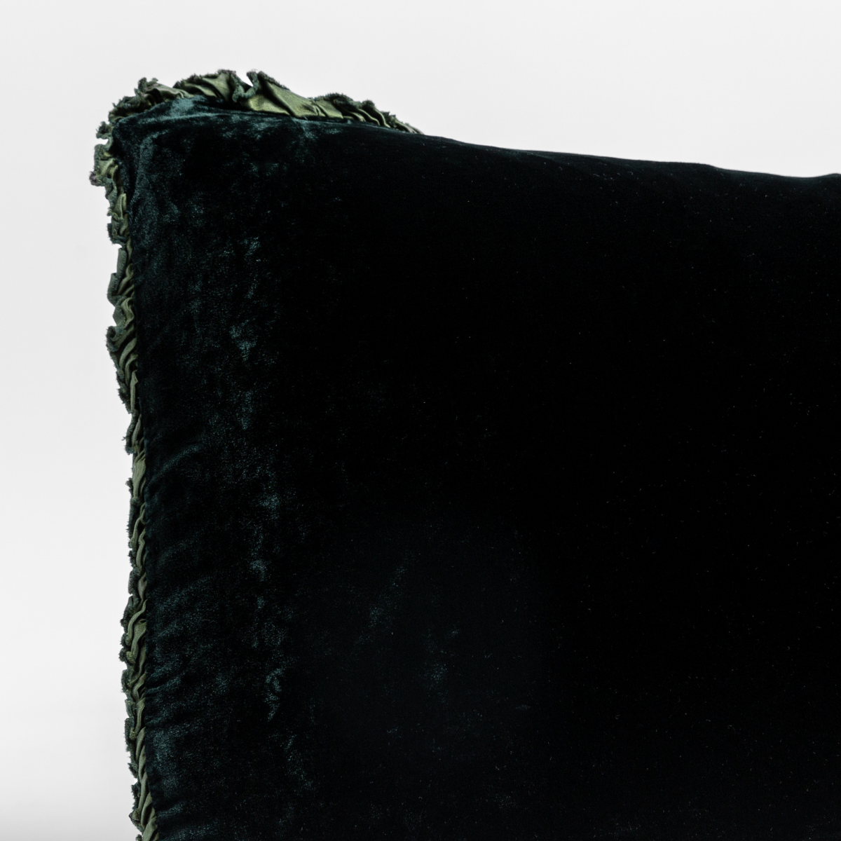 Carmen Throw Pillow | Juniper | a close up of the corner of a charmeuse trimmed silk velvet pillow