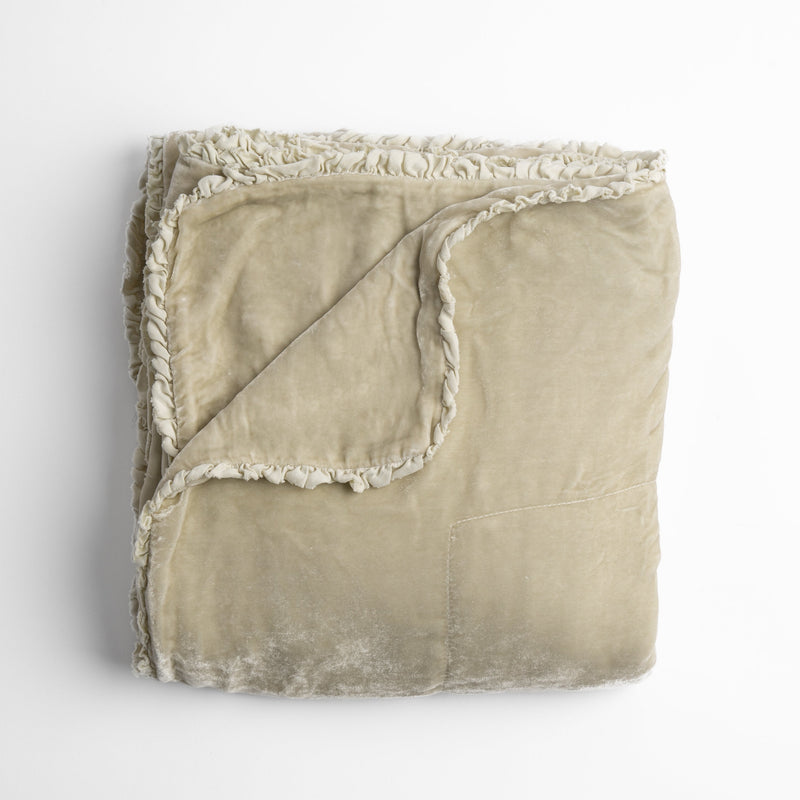 Carmen Blanket | Parchment | silk velvet unfilled throw blanket with a petite charmeuse ruffle trim, overhead on a white background.
