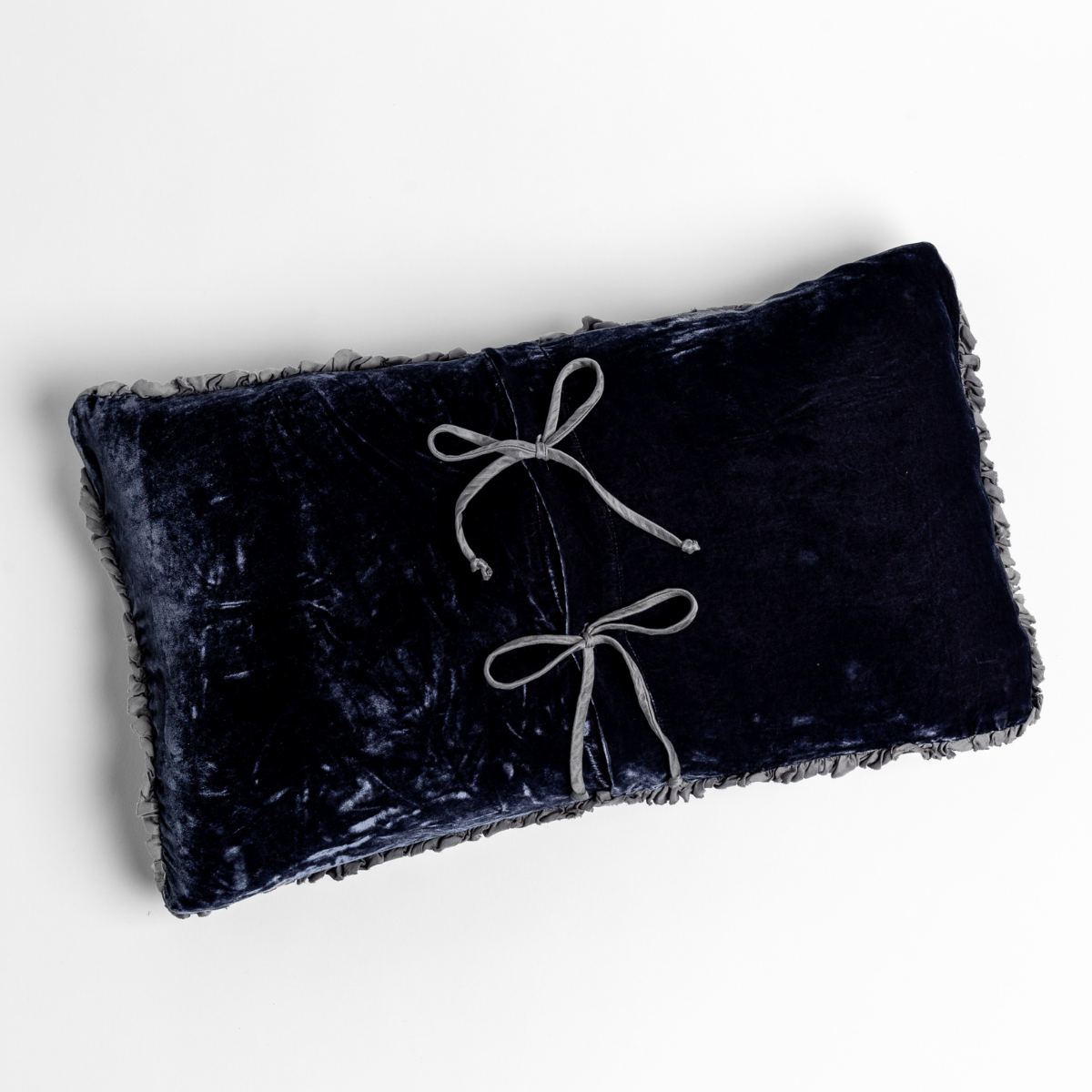 Carmen Throw Pillow | French Lavender | silk velvet throw pillow with charmeuse trim shot overhead against a white background with its tie closures showing.