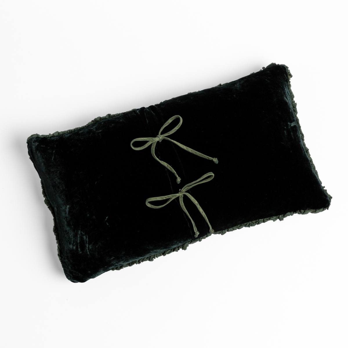 Carmen Throw Pillow | Juniper | silk velvet throw pillow with charmeuse trim shot overhead against a white background with its tie closures showing.