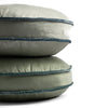 Paloma Throw Pillow | two 18-inch round pillows stacked against a white background, showing the silk velvet trim on the pillow gussets — Mineral and Eucalyptus.