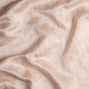 Taline Blanket | Pearl | A close up of charmeuse fabric in pearl, a nude-like, soft rose pink tone.