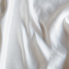 Charmeuse Swatch | Winter White | A close up of silk linen charmeuse fabric in winter white, softer and warmer in tone than classic white.