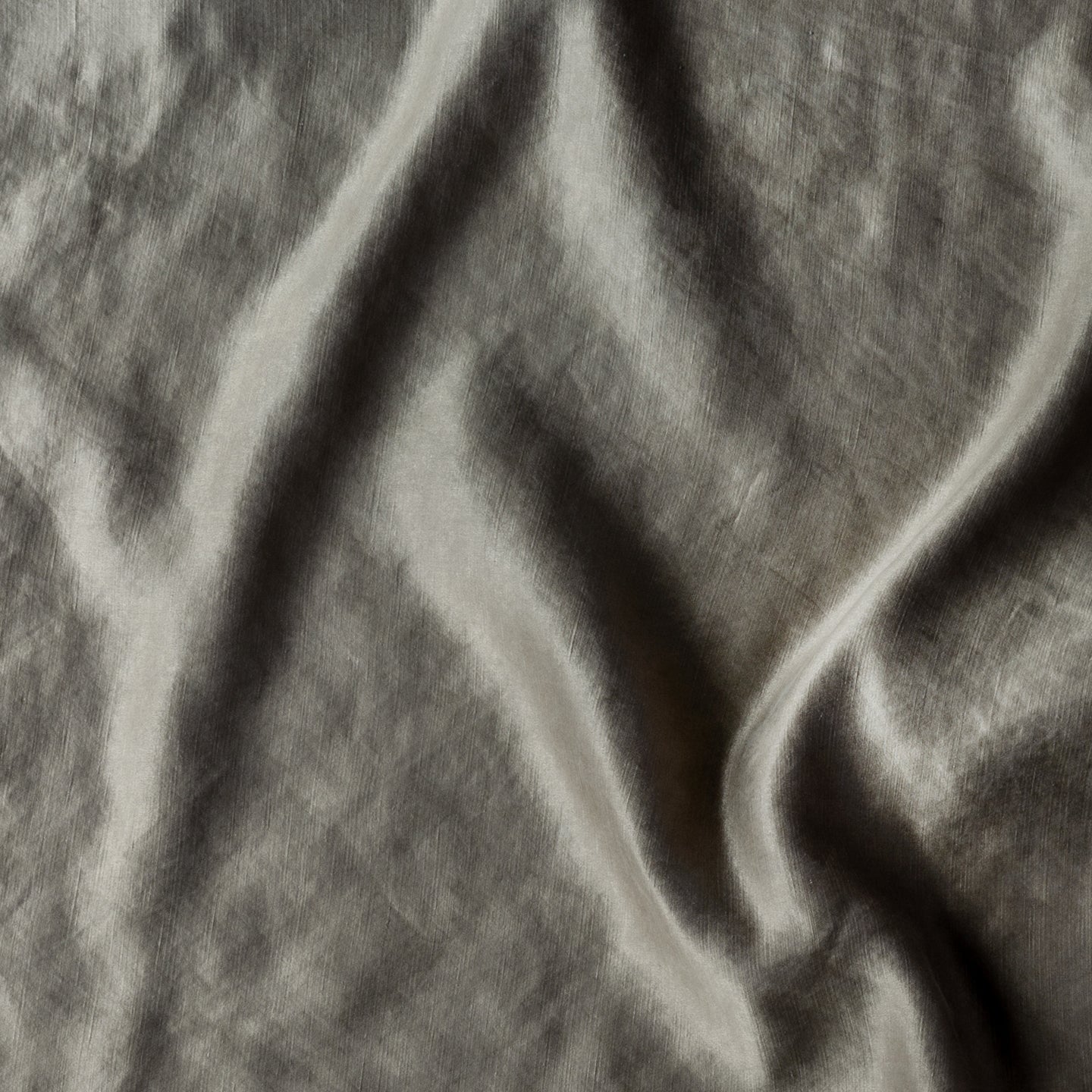 Moonlight: Close-up of silk charmeuse in moonlight, a saturated, cool, mid-dark grey tone. 