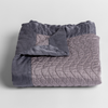 Cirillo Baby Blanket | French Lavender | a folded quilted cotton sateen baby blanket with its corner folded down to show the trim contrast - shot against a white background.