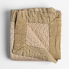 Cirillo Blanket | Honeycomb | a folded quilted cotton sateen throw blanket with its corner folded down to show the trim contrast - shot against a white background.
