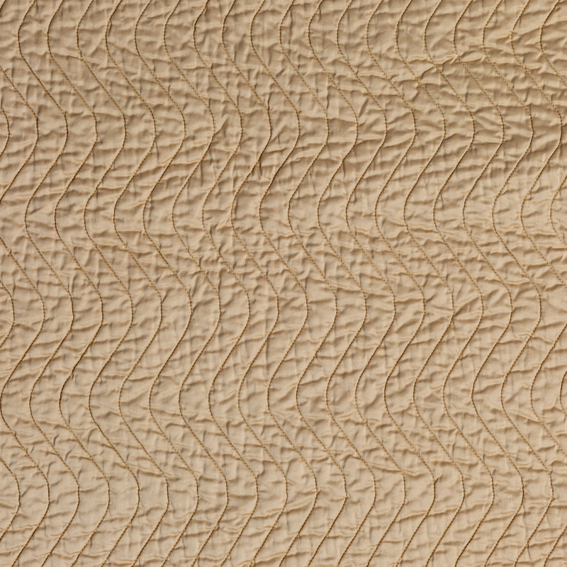 Cirillo Coverlet | Honeycomb | A close up of quilted cotton sateen fabric in honeycomb, a warm golden tone.