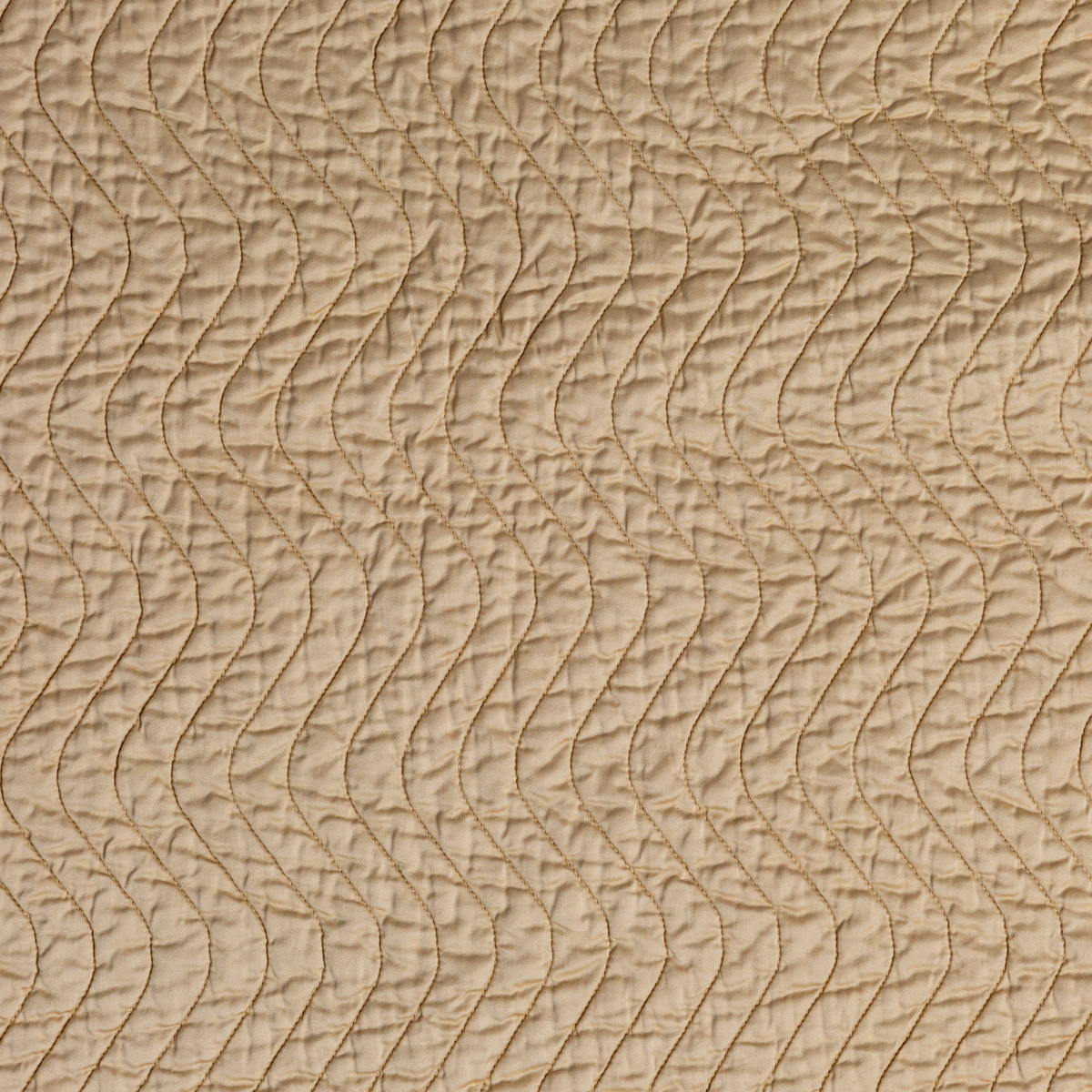 Cirillo Twin Coverlet | Honeycomb | A close up of quilted cotton sateen fabric in honeycomb, a warm golden tone.