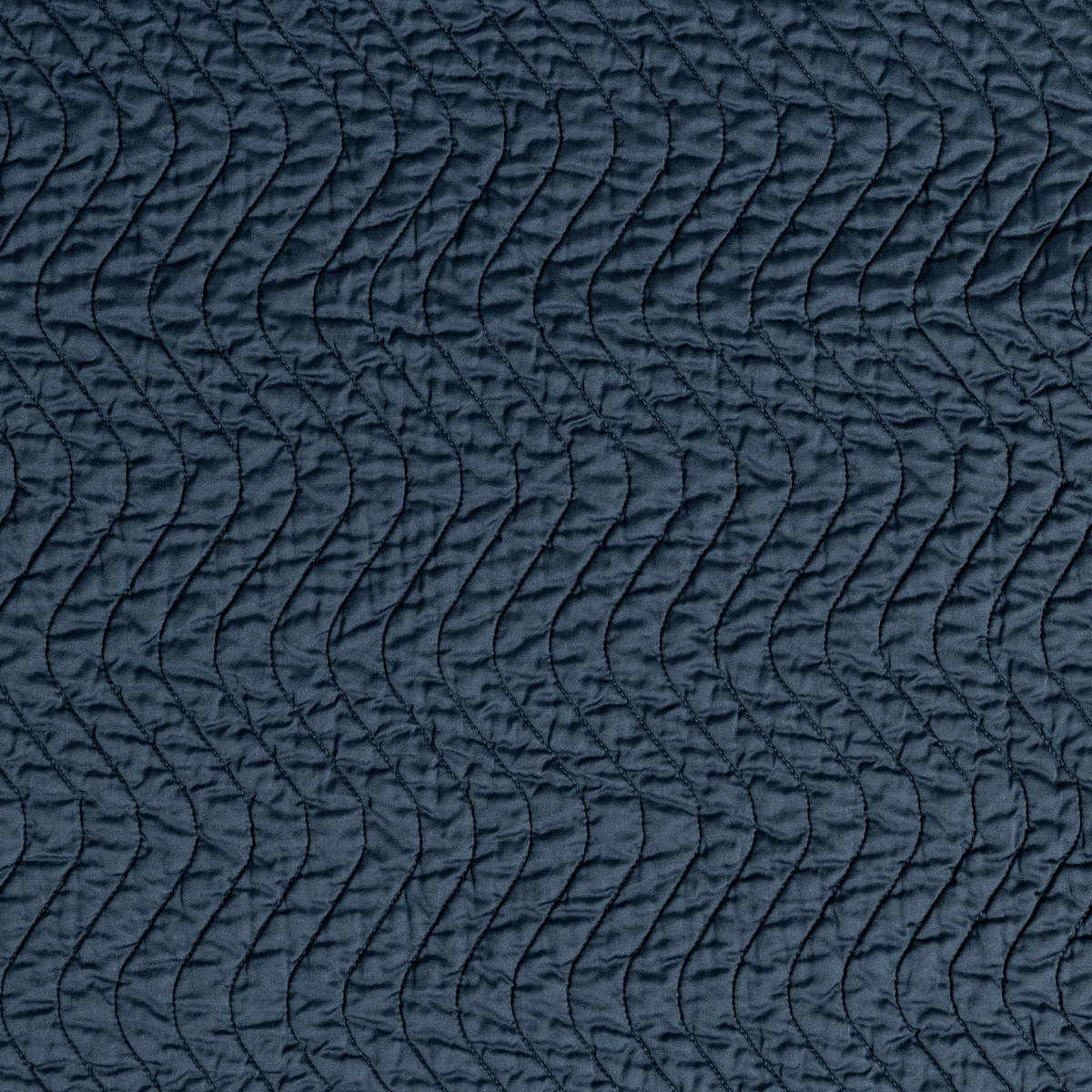 Cirillo Twin Coverlet | Midnight | A close up of quilted cotton sateen fabric in midnight, a rich indigo tone.