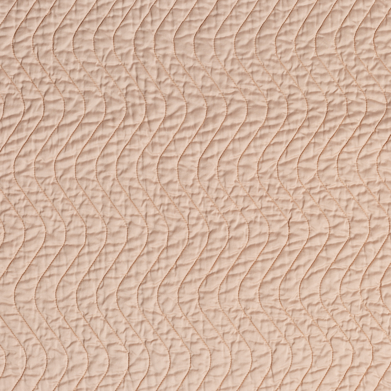 Cirillo Baby Blanket | Pearl | A close up of quilted cotton sateen fabric in pearl, a nude-like, soft rose pink tone.