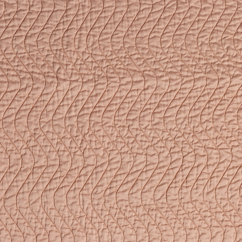 Cirillo Baby Blanket | Rouge | A close up of quilted cotton sateen fabric in rouge, a mid-tone blush pink.