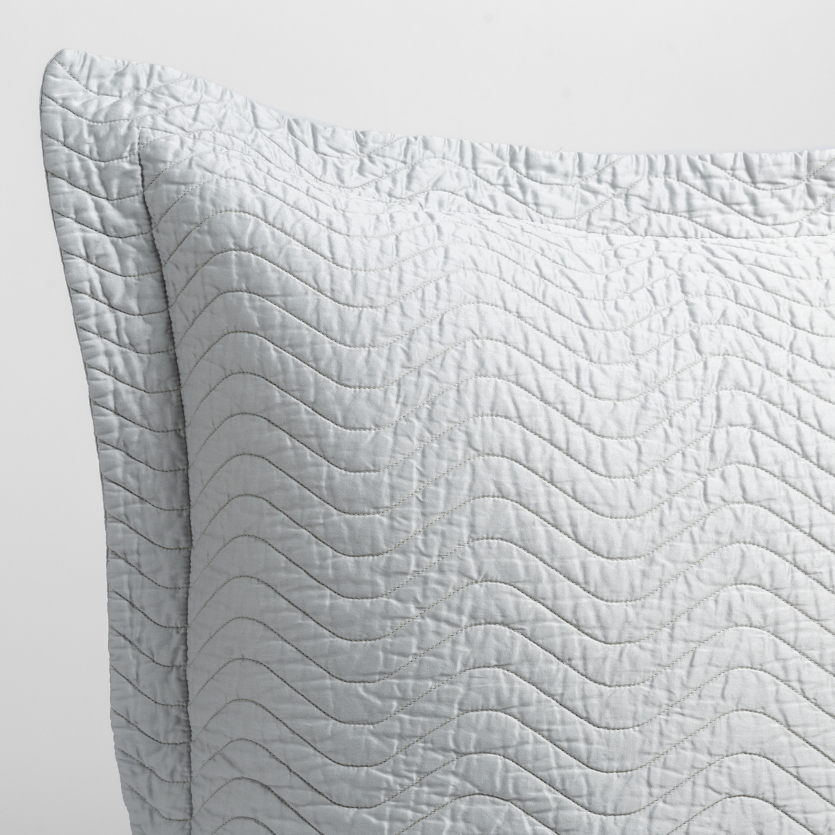 Cirillo Sham | Cloud | close up of the corner of a quilted cotton sateen pillow sham - shot against a white background.