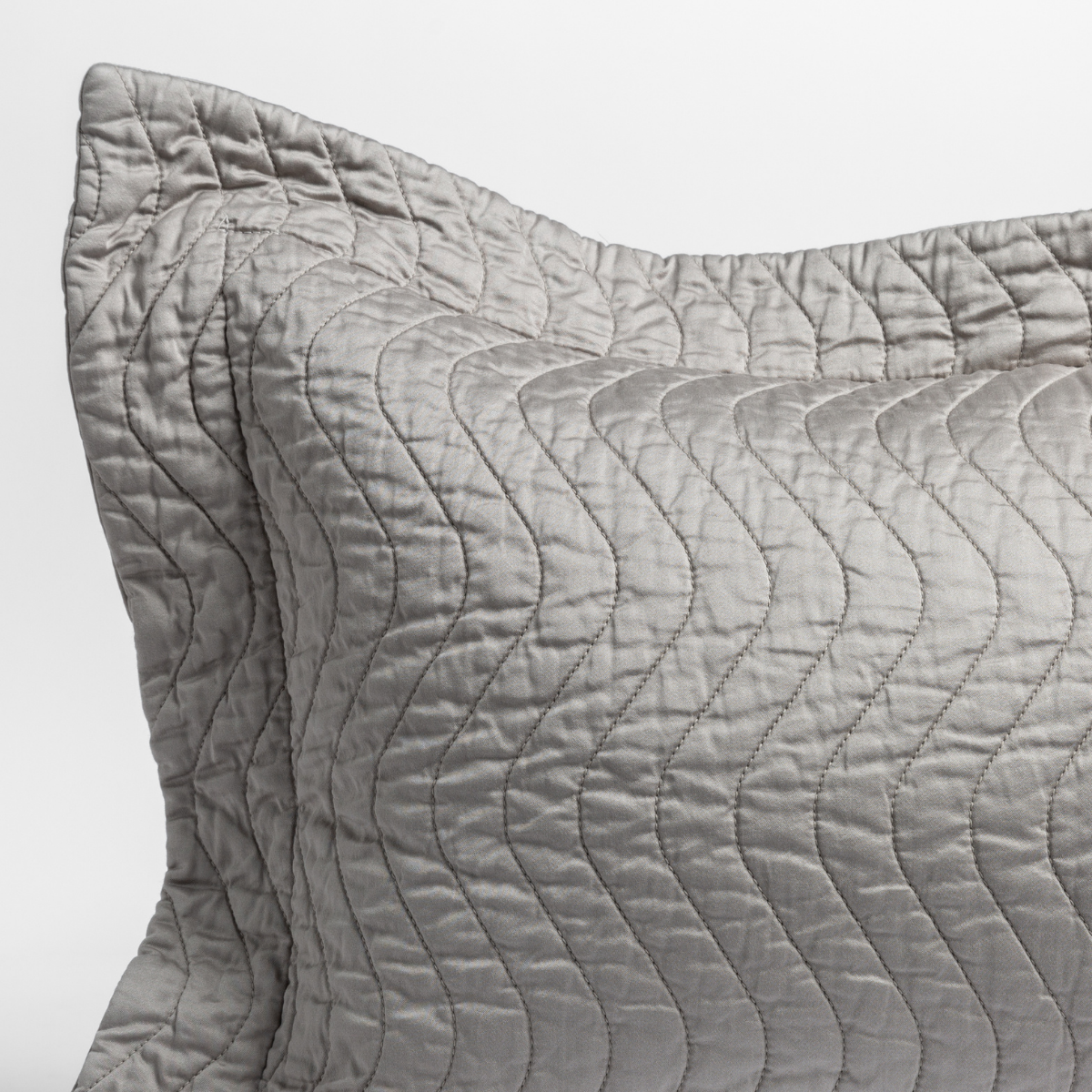 Cirillo Sham | Mineral | close up of the corner of a quilted cotton sateen pillow sham - shot against a white background.