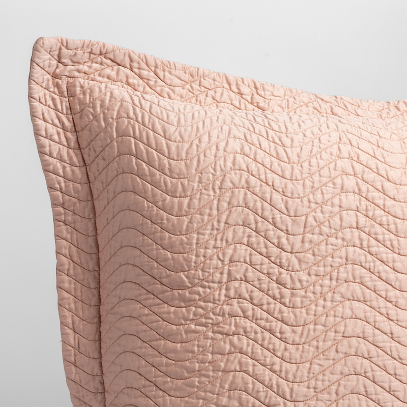 Cirillo Sham | Rouge | close up of the corner of a quilted cotton sateen pillow sham - shot against a white background.