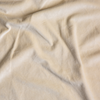 Harlow Crib Skirt | Parchment | A close up of cotton velvet fabric in parchment, a warm, antiqued cream.