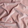 Harlow Crib Skirt | Rouge | A close up of cotton velvet fabric in rouge, a mid-tone blush pink.