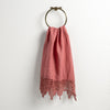Frida Guest Towel | Poppy | Lace trimmed linen guest towel  draped through a decorative towel ring against a plain white background.