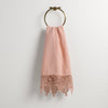 Frida Guest Towel | Rouge | Lace trimmed linen guest towel  draped through a decorative towel ring against a plain white background.