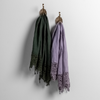 Frida Guest Towel | pair of frida lace trimmed linen guest towels on decorative hooks against a white wall.