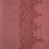 Linen Flat Sheet | Poppy | A close up of frida lace trimmed linen fabric in poppy, a warm coral pink.