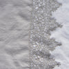 Frida Pillowcase (Single) | Fog | A close up of Frida, an antique cotton lace trim on a linen body, shown in fog, a neutral-warm, soft mid-tone grey.