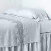 Linen Flat Sheet | Cloud | lace trimmed flat sheet shown with monochromatic bedding - side view.