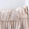 Linen Flat Sheet | Pearl | lace trimmed flat sheet shown with monochromatic bedding - side view.