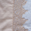 Frida Pillowcase (Single) | Pearl | A close up of Frida, an antique cotton lace trim on a linen body, shown in pearl, a nude-like, soft rose pink tone.