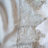 Frida Flat Sheet | Sterling | A close up of Frida, an antique cotton lace trim on a linen body, shown in sterling, a silvery neutral light grey.