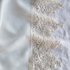 Frida Pillowcase (Single) | Winter White | A close up of Frida, an antique cotton lace trim on a linen body, shown in winter white, softer and warmer in tone than classic white.