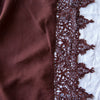 Frida Flat Sheet | Mahogany | A close up of Frida, an antique cotton lace trim on a linen body, shown in mahogany, a deep, earthen, reddish brown.
