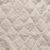 Harlow Coverlet | Parchment | A close up of quilted cotton velvet fabric in parchment, a warm, antiqued cream.