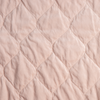 Harlow Twin Coverlet | Pearl | A close up of quilted cotton velvet fabric in pearl, a nude-like, soft rose pink tone.