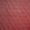 Harlow Twin Coverlet | Poppy | A close up of quilted cotton velvet fabric in poppy, a warm coral pink.