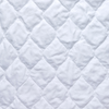 Harlow Coverlet | White | A close up of quilted cotton velvet fabric in classic white.