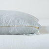 Ines Throw Pillow | Cloud | Close-up of brass zipper and charmeuse pull details on throw pillow - side view.
