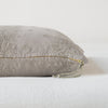 Ines Throw Pillow | Fog | Close-up of brass zipper and charmeuse pull details on throw pillow - side view.