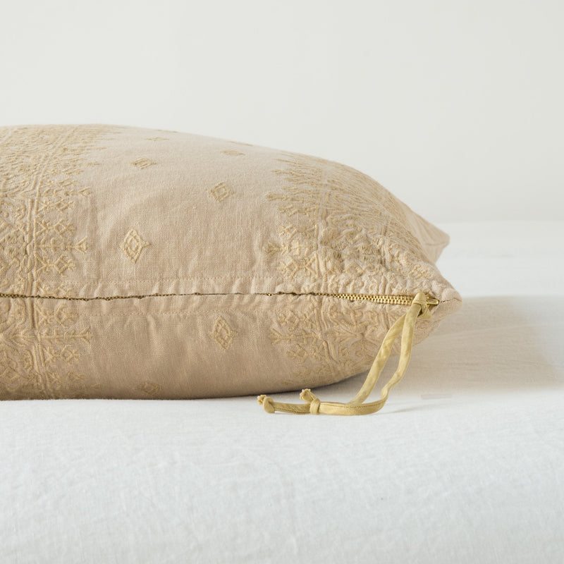 Ines Throw Pillow | Honeycomb | Close-up of brass zipper and charmeuse pull details on throw pillow - side view.