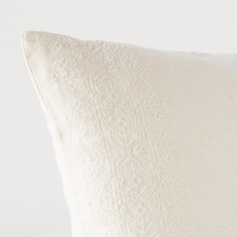 Ines Throw Pillow | Parchment | Close-up of pillow corner, showcasing the embroidery pattern detail.