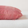 Ines Throw Pillow | Poppy | Close-up of brass zipper and charmeuse pull details on throw pillow - side view.