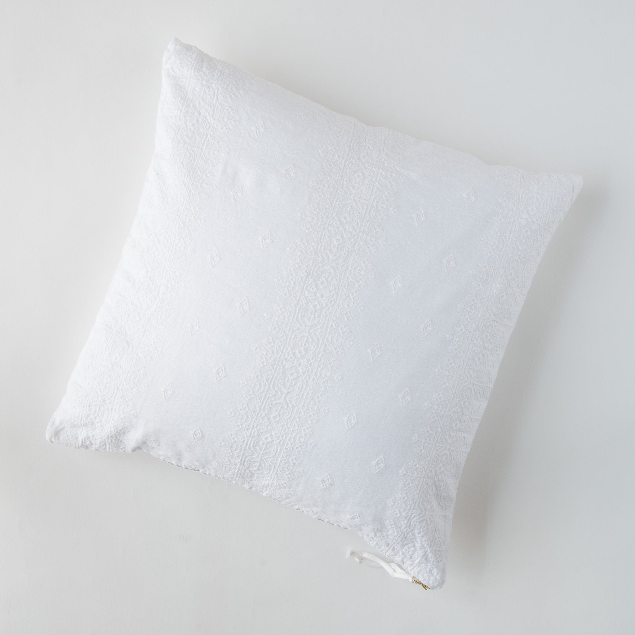 Ines Throw Pillow | White | pillow on a white background - overhead view.