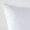 Ines Throw Pillow | White | Close-up of pillow corner, showcasing the embroidery pattern detail.