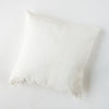 Ines Throw Pillow | Winter White | pillow on a white background - overhead view.