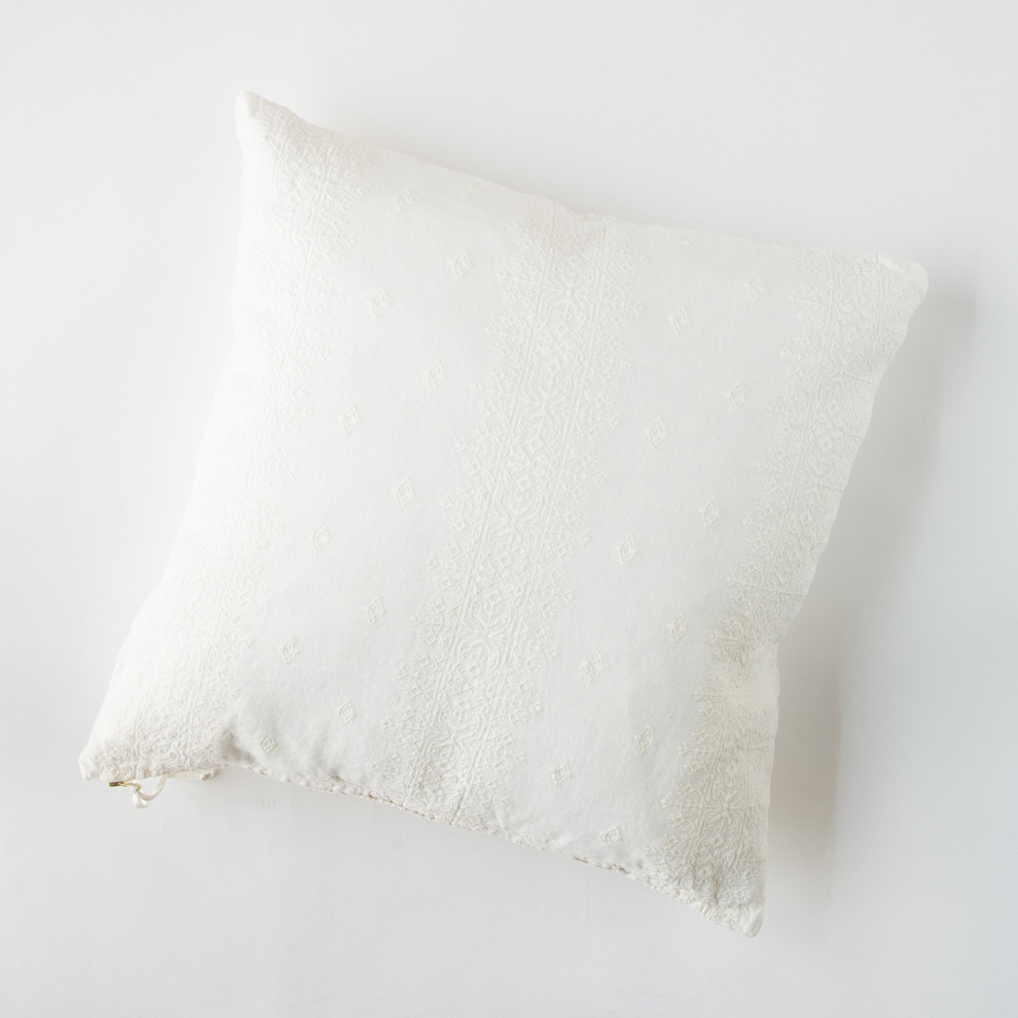 Ines Throw Pillow | Winter White | pillow on a white background - overhead view.